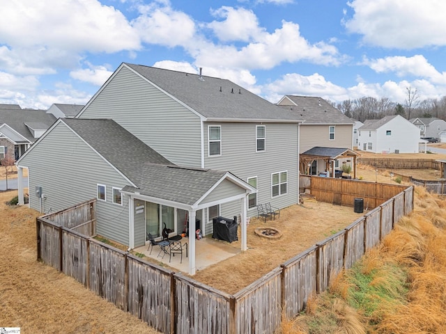 rear view of property with an outdoor fire pit and a patio