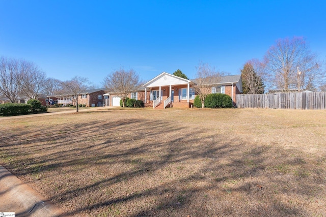 ranch-style home with a front lawn and covered porch