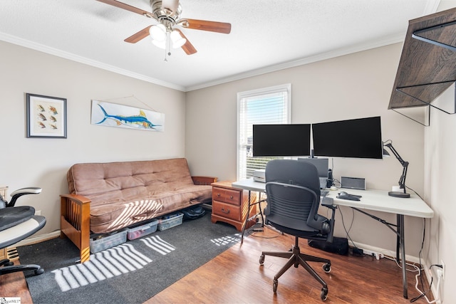 office area with a textured ceiling, wood-type flooring, ornamental molding, and ceiling fan