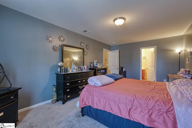 carpeted bedroom with ensuite bath