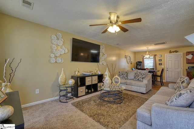 carpeted living room featuring a textured ceiling and ceiling fan