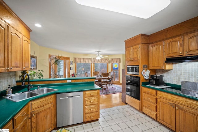 kitchen featuring sink, light tile patterned floors, ceiling fan, black appliances, and decorative backsplash