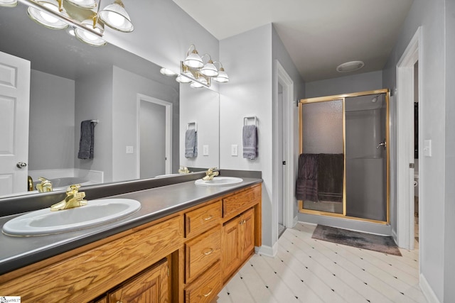 bathroom with vanity and a shower with shower door