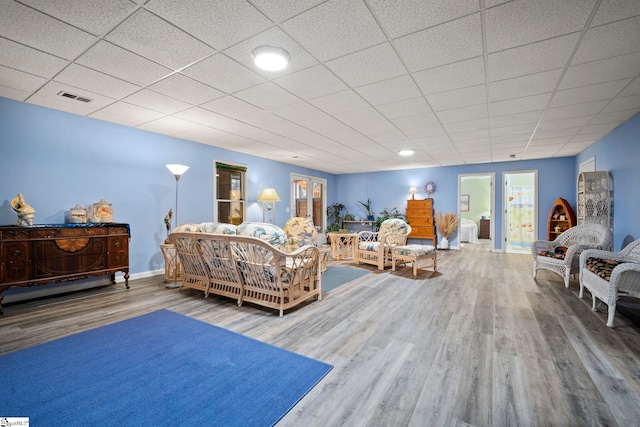 bedroom with a drop ceiling and hardwood / wood-style floors