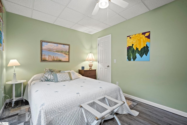 bedroom with wood-type flooring and a paneled ceiling