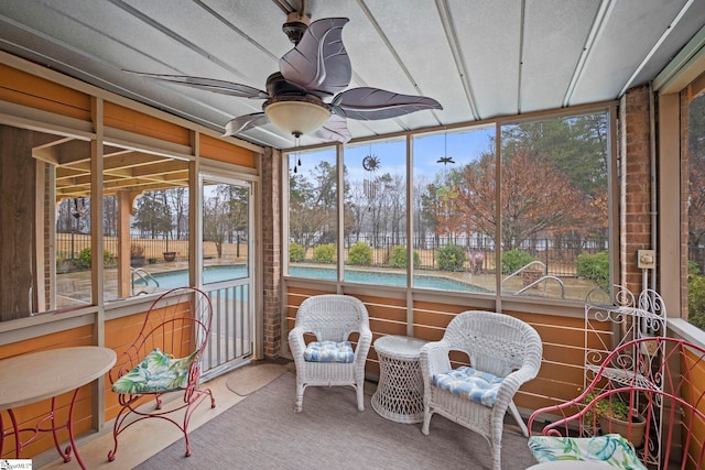 sunroom / solarium featuring ceiling fan