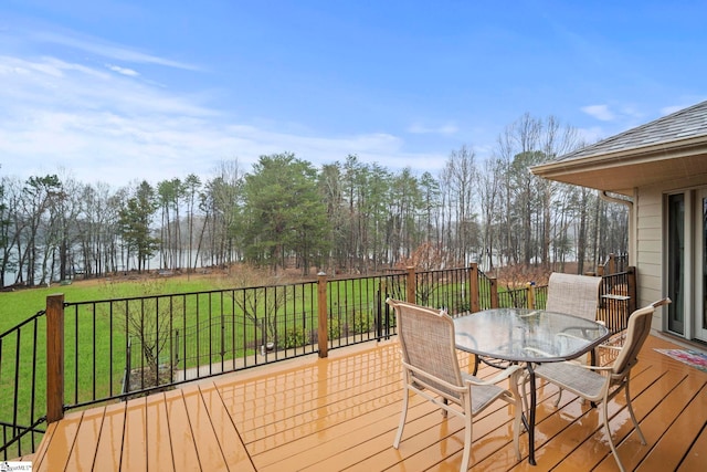 deck with a water view and a lawn