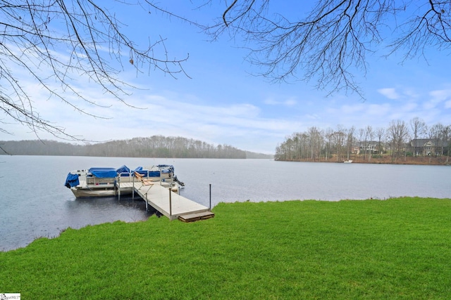 view of dock featuring a water view and a yard