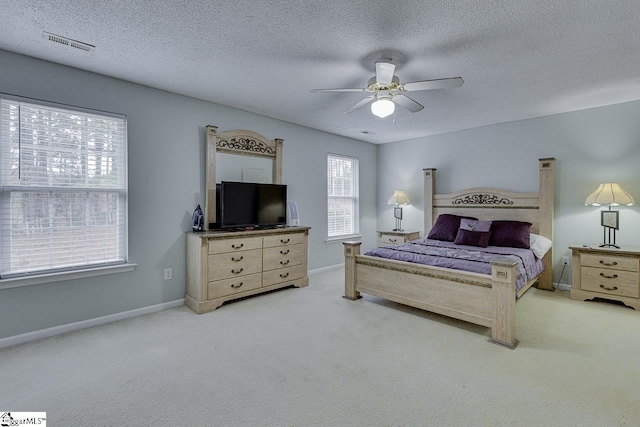 bedroom featuring ceiling fan, carpet floors, and a textured ceiling