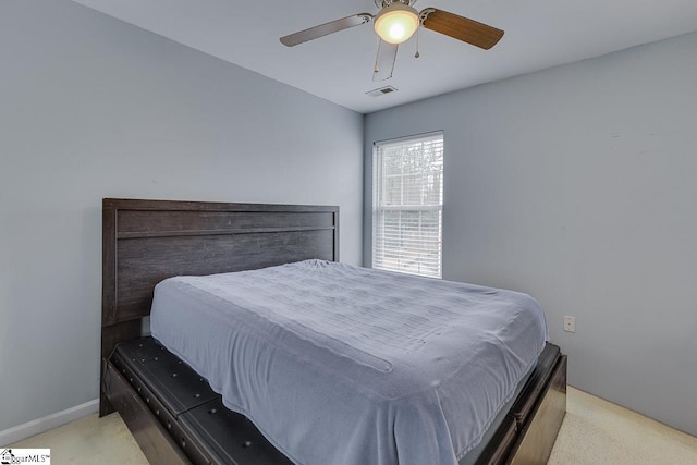 bedroom with light carpet and ceiling fan