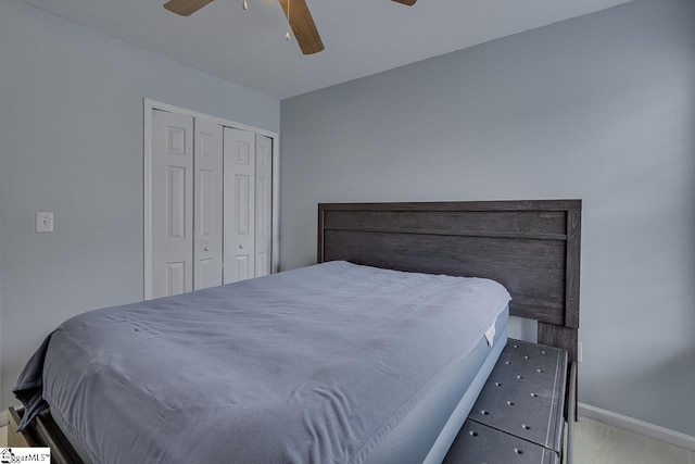 carpeted bedroom featuring a closet and ceiling fan