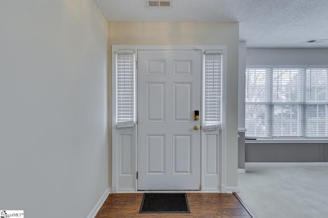 entryway with a textured ceiling