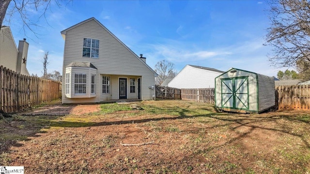 back of property with a storage shed and a lawn