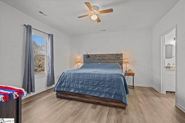 bedroom with ceiling fan, sink, and light wood-type flooring