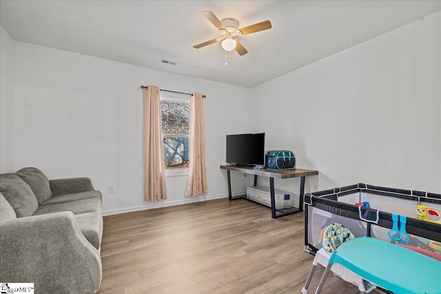 recreation room featuring ceiling fan and light wood-type flooring