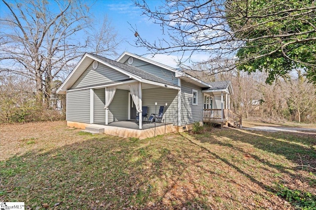 view of home's exterior with a lawn and a patio