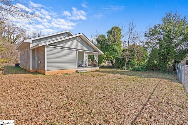 exterior space featuring a yard, central air condition unit, and a porch