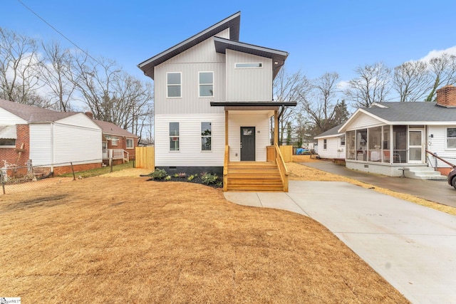 view of front of property featuring a sunroom and a front yard