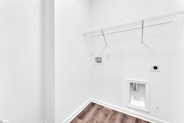 laundry room with dark wood-type flooring, hookup for a washing machine, and electric dryer hookup