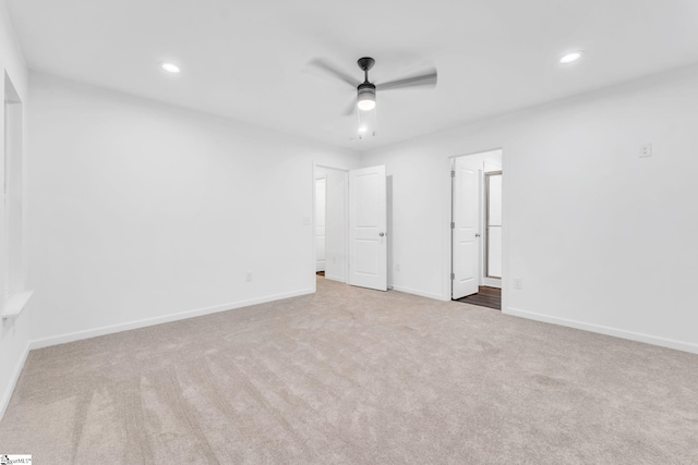 unfurnished bedroom featuring carpet floors, ceiling fan, and ensuite bathroom