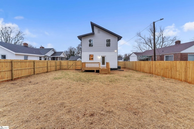 back of property featuring a yard and a deck