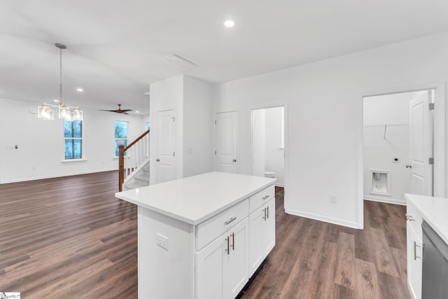 kitchen with dark hardwood / wood-style floors, decorative light fixtures, dishwasher, white cabinets, and a center island