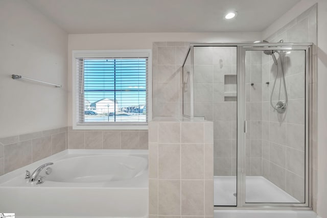 bathroom with separate shower and tub