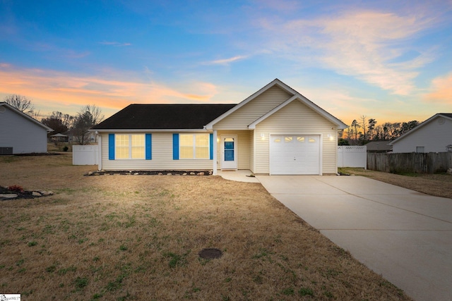 ranch-style house featuring a garage and a lawn