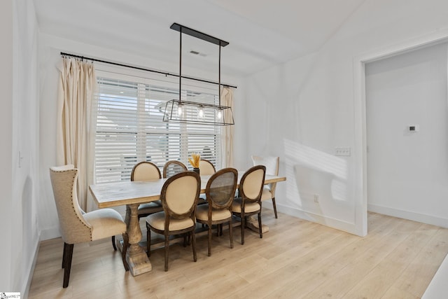 dining room with a notable chandelier and light hardwood / wood-style floors