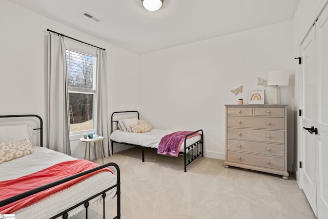 carpeted bedroom with a closet