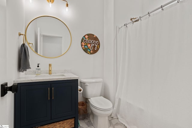 bathroom featuring vanity, walk in shower, and toilet