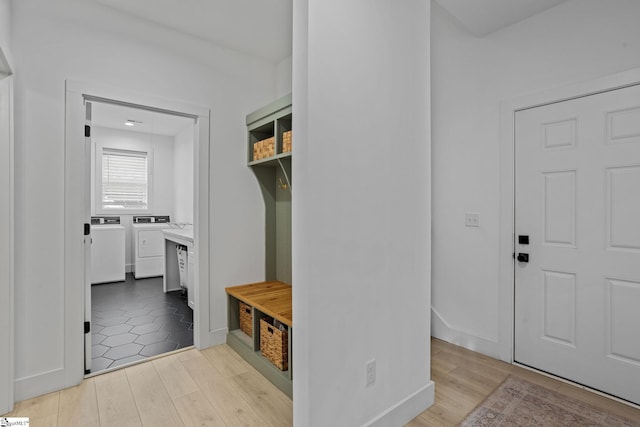 mudroom featuring separate washer and dryer and light wood-type flooring