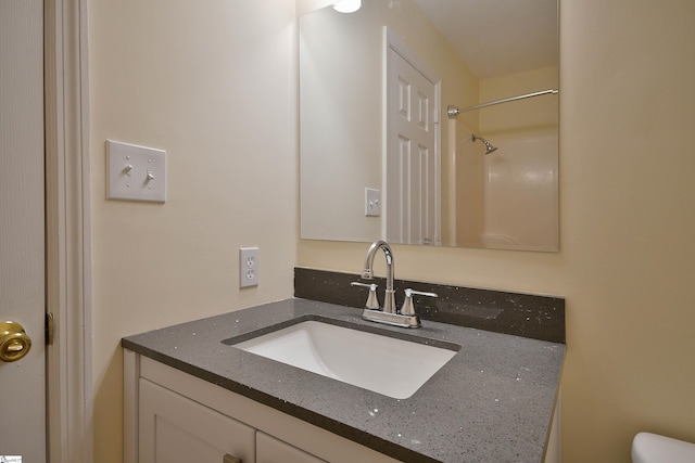 bathroom featuring vanity and a shower