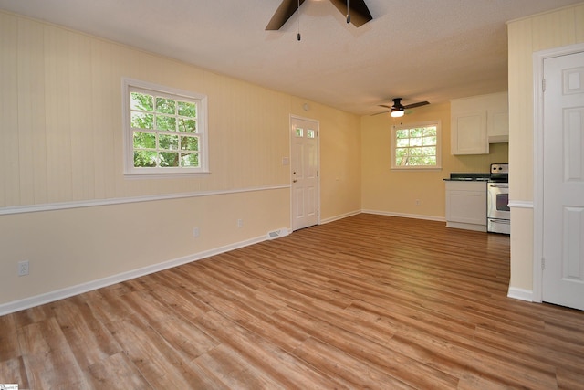 unfurnished living room with light hardwood / wood-style floors and ceiling fan