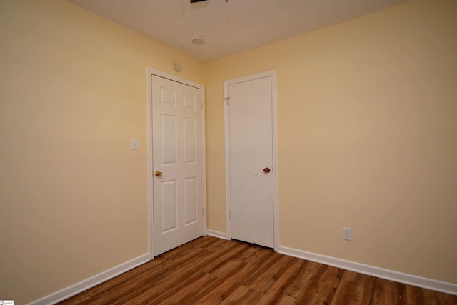 unfurnished bedroom featuring dark wood-type flooring