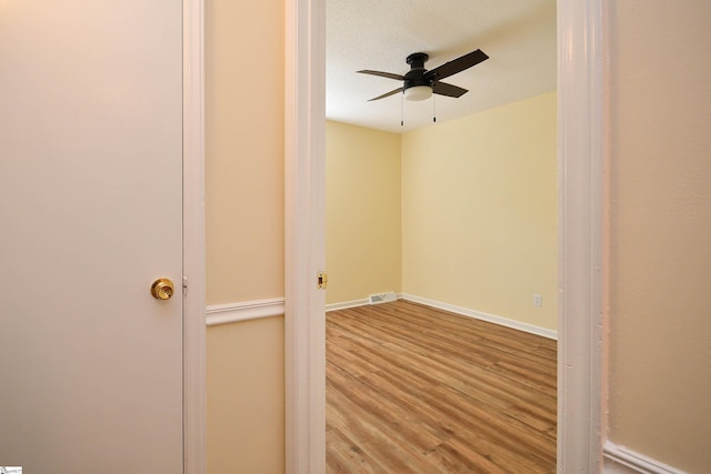 spare room featuring hardwood / wood-style flooring, a textured ceiling, and ceiling fan