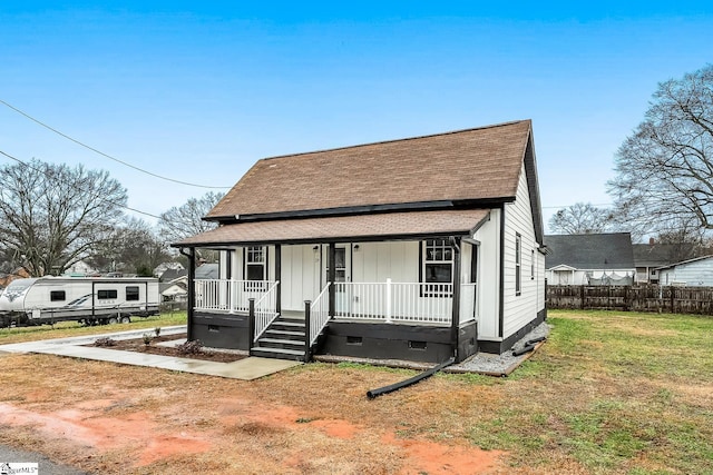 bungalow-style house featuring a porch and a front lawn