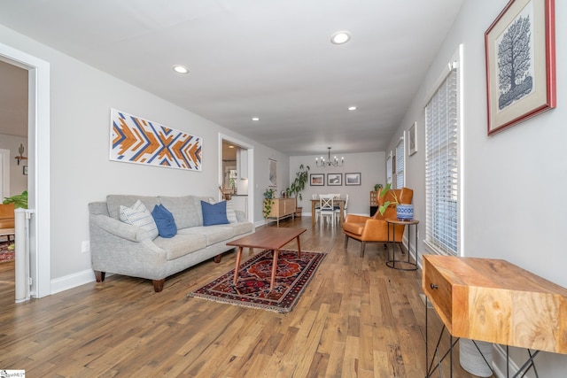 living room with a notable chandelier and hardwood / wood-style flooring