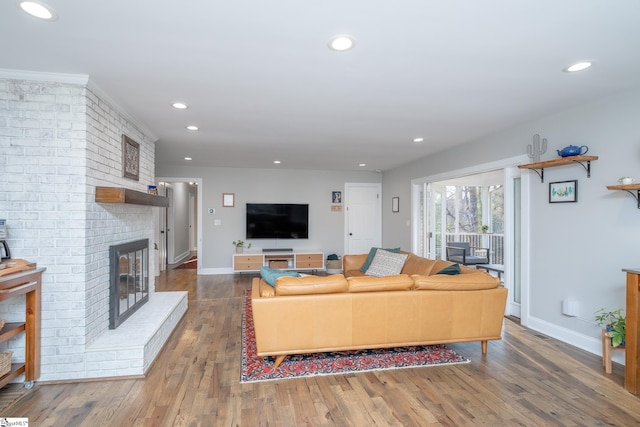 living room with wood-type flooring and a fireplace