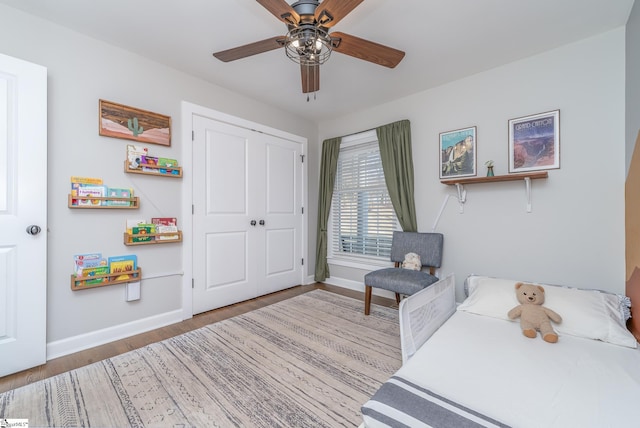 bedroom featuring hardwood / wood-style floors, a closet, and ceiling fan