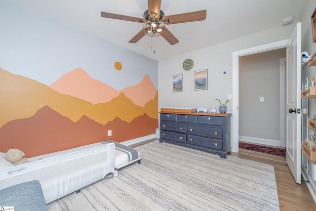 bedroom featuring light hardwood / wood-style flooring and ceiling fan