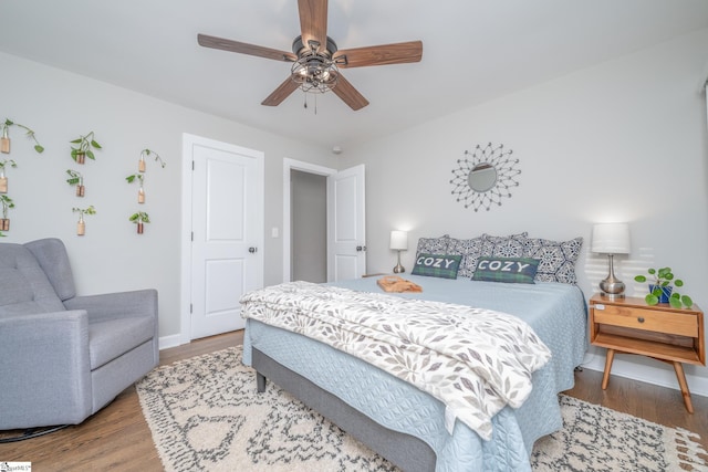 bedroom with hardwood / wood-style flooring and ceiling fan