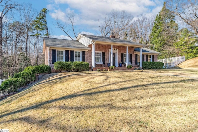 view of front facade with a front yard and a porch