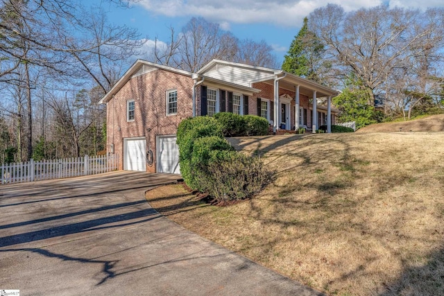 view of front of home with a garage and a front lawn