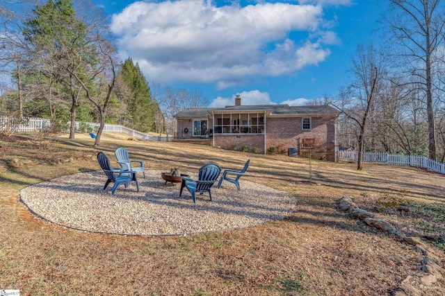 rear view of property with an outdoor fire pit