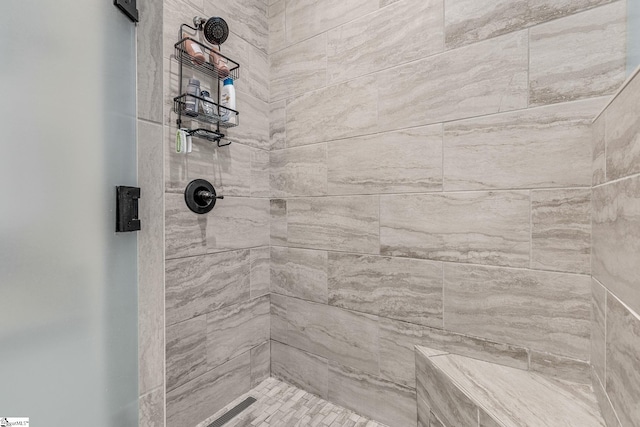 bathroom with tiled shower