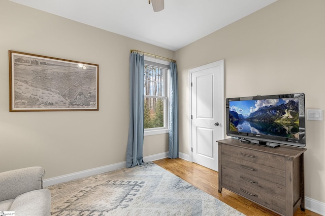 sitting room featuring ceiling fan and light wood-type flooring