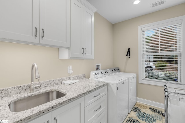 laundry room with cabinets, sink, light tile patterned floors, and independent washer and dryer