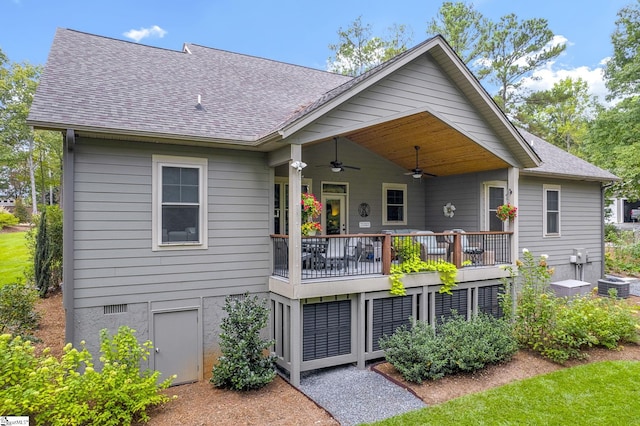 back of property with ceiling fan