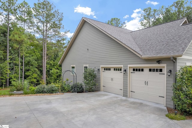 view of side of home with a garage